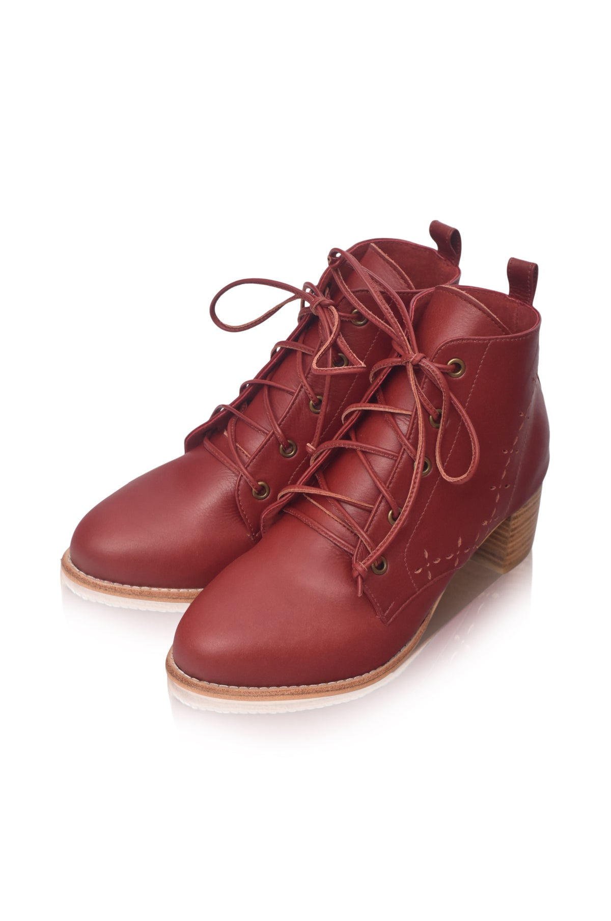 A pair of red leather lace-up ankle boots with a low stacked heel and light tan sole, shown on a white background.