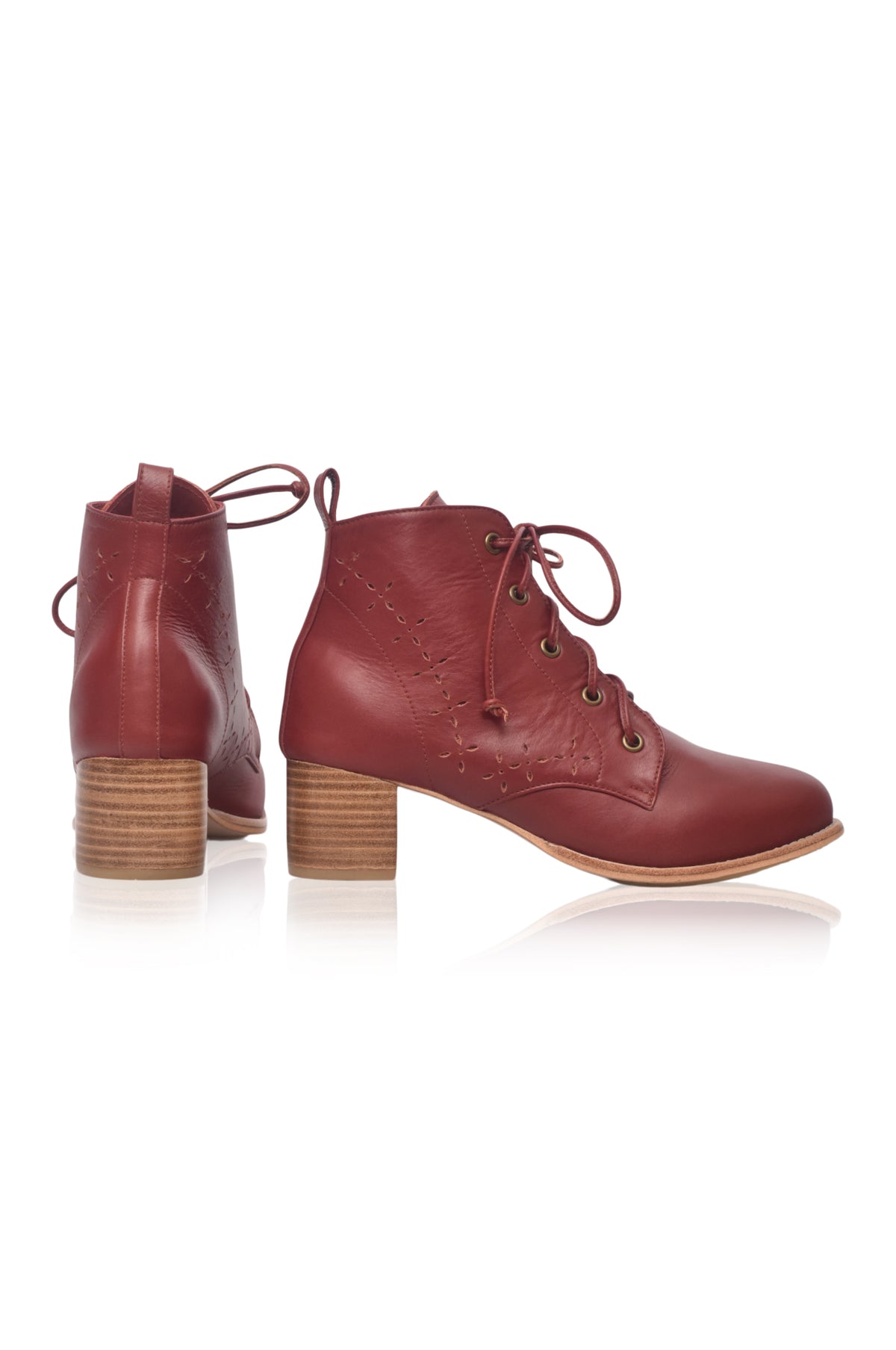 A pair of women's low-heeled lace-up ankle boots in a reddish-brown leather, featuring embossed floral details, wooden block heels, and a light tan sole, shown against a white background.