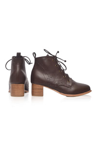 A pair of dark brown leather lace-up ankle boots with stacked wooden block heels, shown from the side and back on a white background.