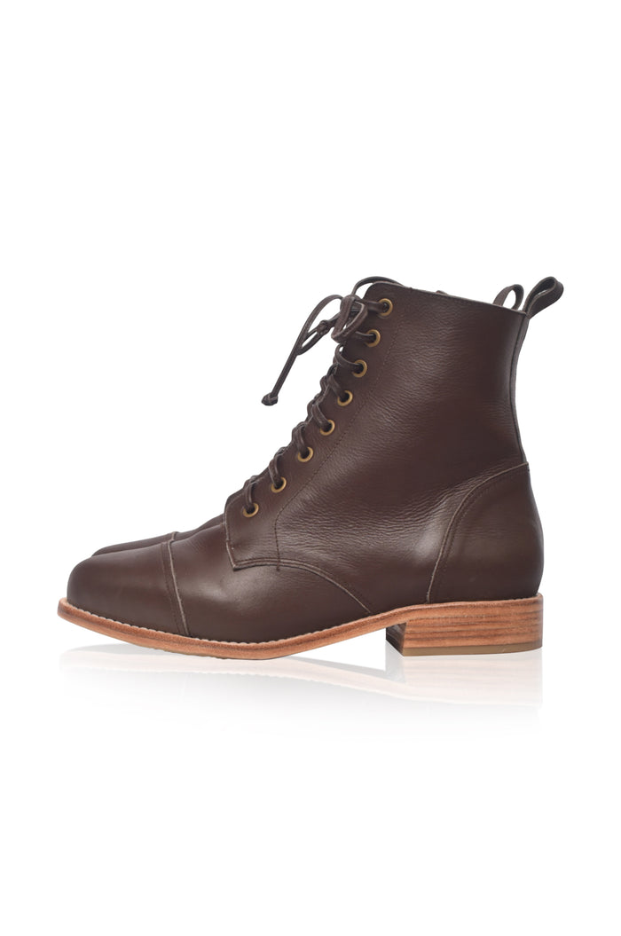 Tan hiking boot on a white background