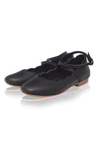 Pair of black flat shoes with a strap on a white background