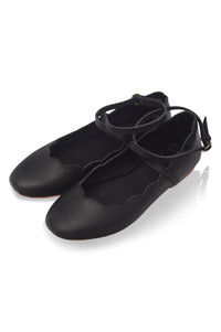 Pair of black shoes with lace-up design on a white background