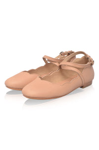 Pair of beige ballet flats on a white background