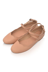 Pair of beige ballet flats on a white background