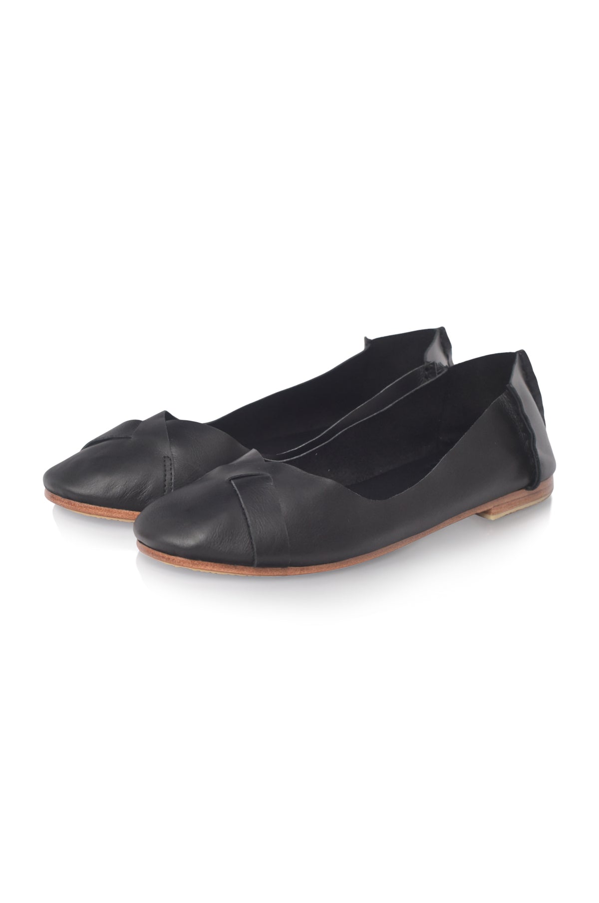 A pair of black leather ballet flats with a pointed toe and decorative side strap, shown on a clean white background.