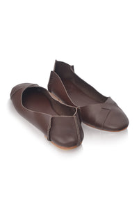 A pair of dark brown leather ballet flats with a pointed toe and a decorative strap detail on the vamp, shown on a white background.