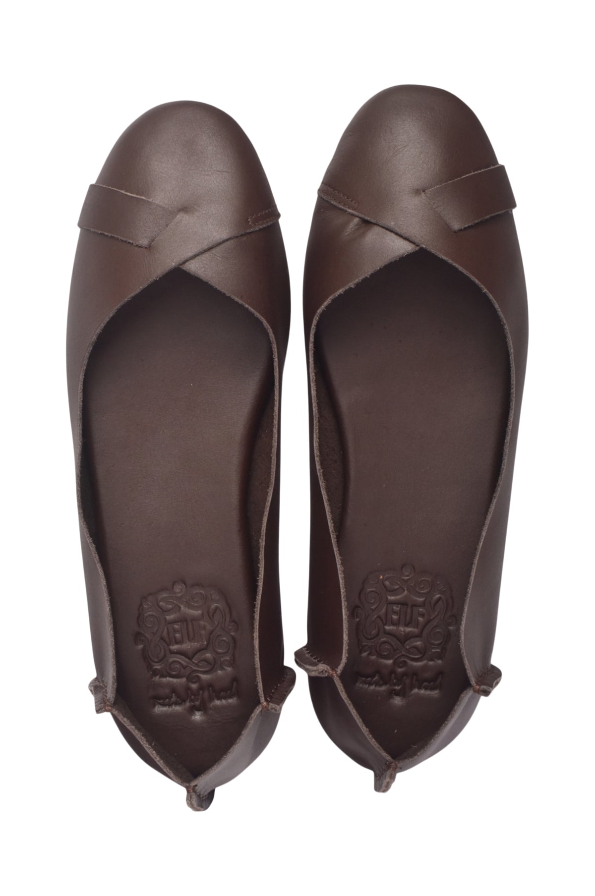 A pair of dark brown leather ballet flats shown from a top-down view, featuring a crossover strap design on the toe and a debossed brand logo on the insole.