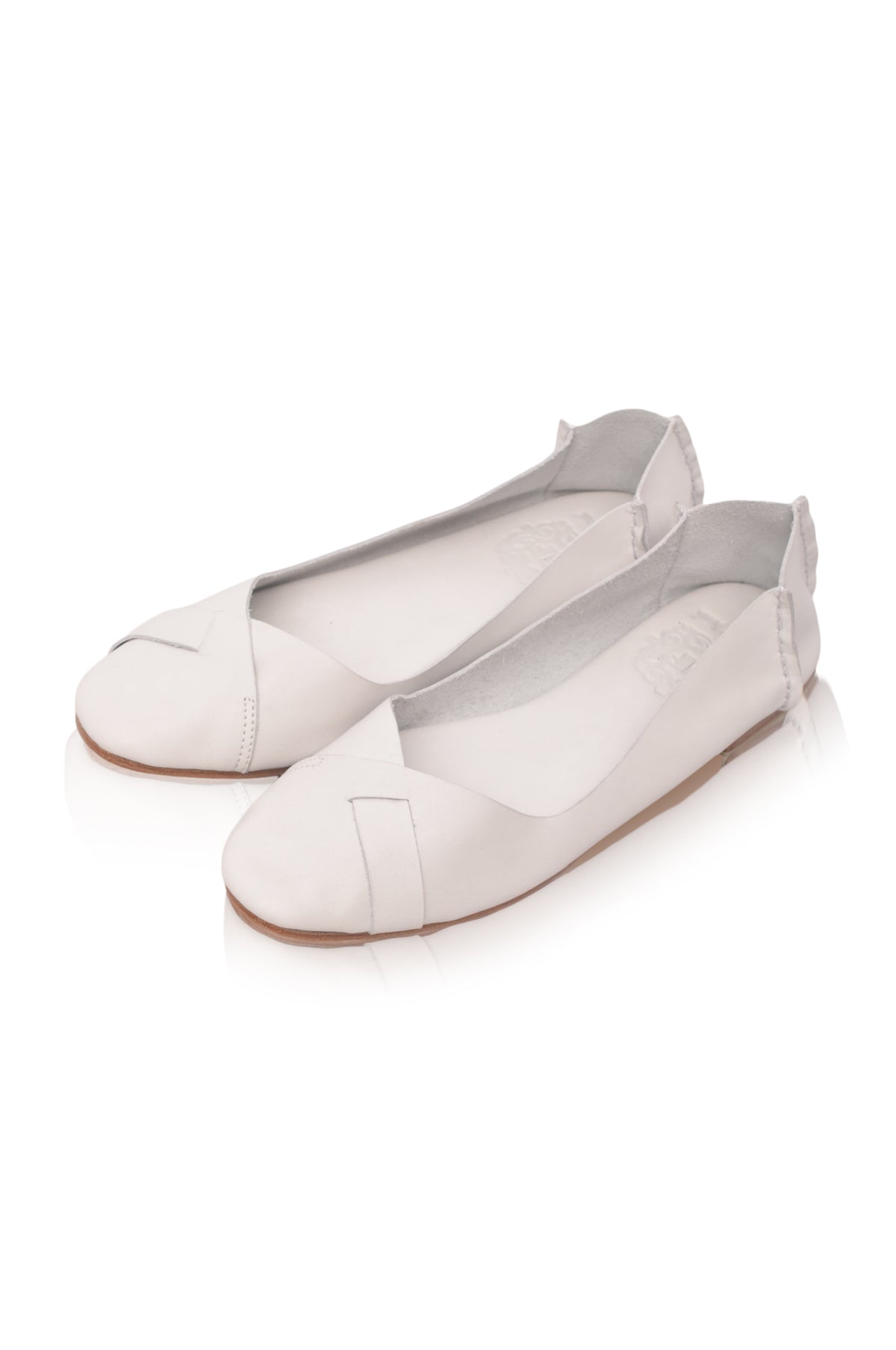 A pair of off-white leather ballet flats with a peep toe and a small wrap-around strap detail, shown on a clean white background.