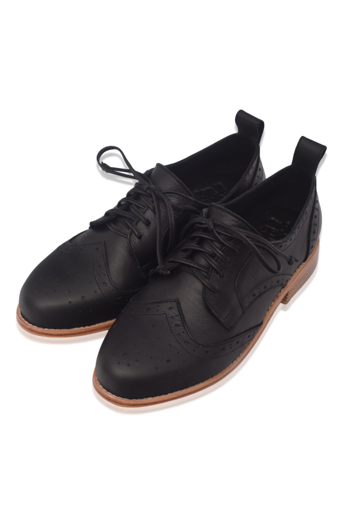 Pair of black leather shoes with brown soles on a white background