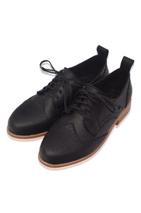 Pair of black leather shoes with brown soles on a white background