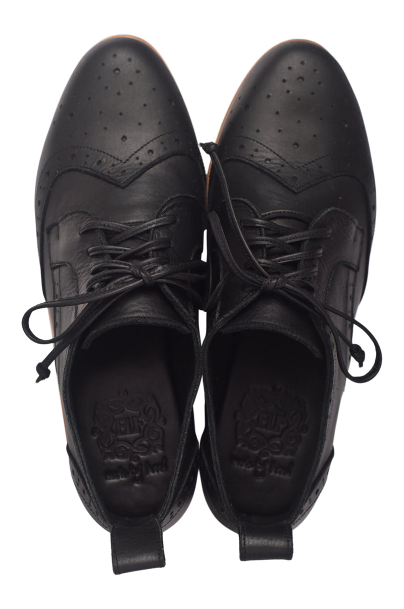 Pair of black leather shoes with laces on a white background