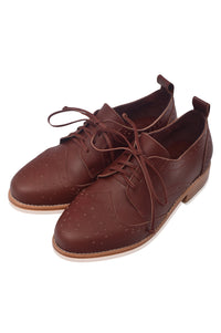 Pair of brown leather shoes with laces on a white background