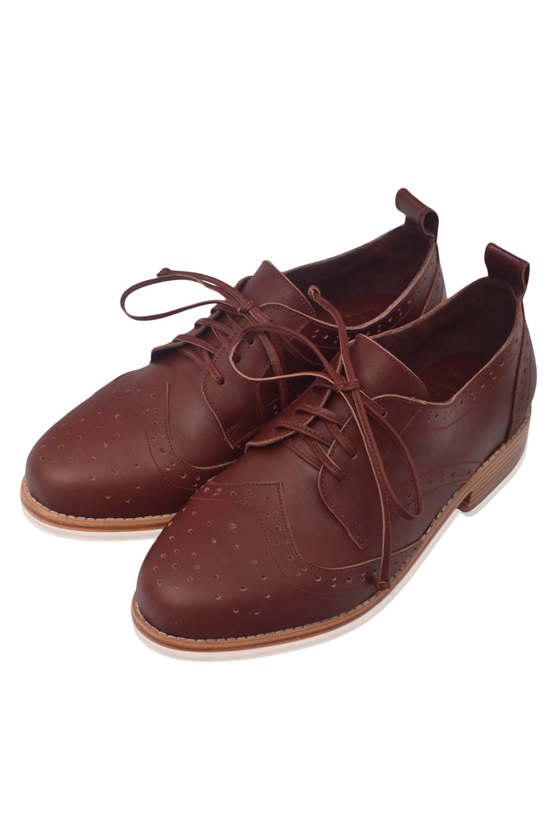 Pair of brown leather shoes with laces on a white background