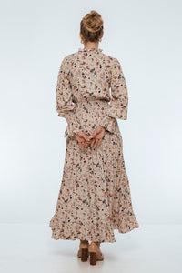 Person wearing a floral dress on a white background