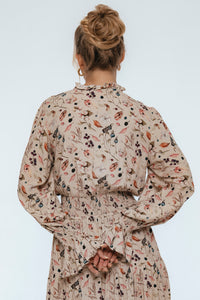 Person wearing a floral patterned dress on a white background