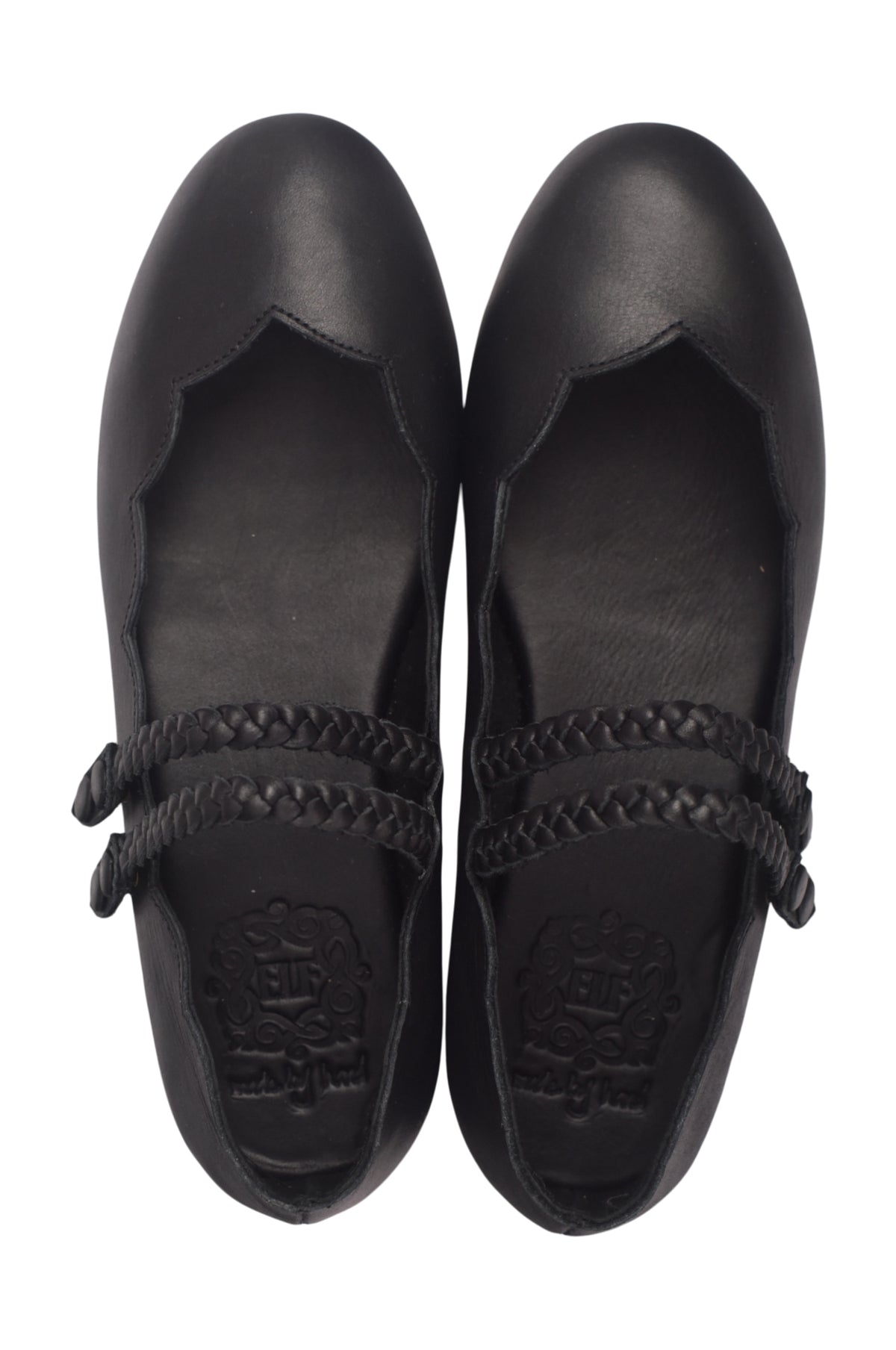 Pair of black shoes with braided details and scallops on a white background