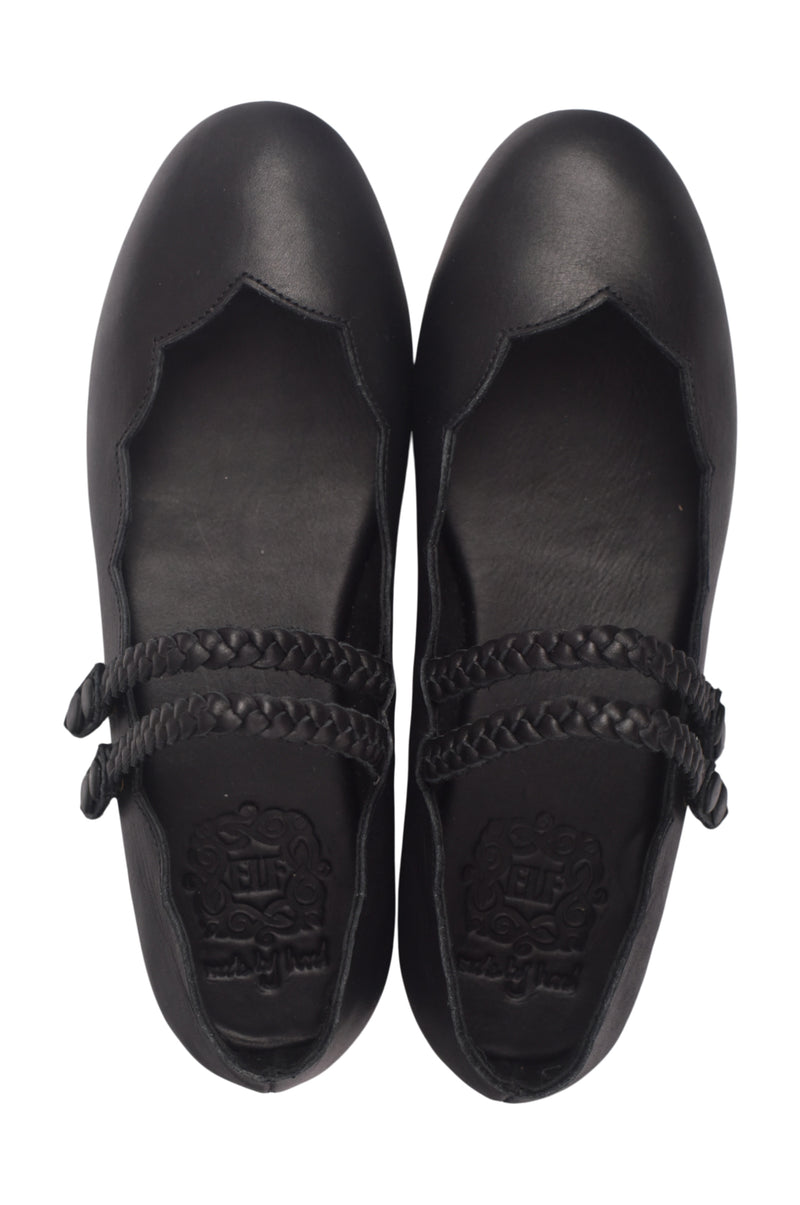 Pair of black shoes with braided details and scallops on a white background