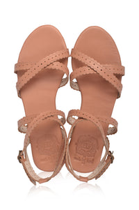 A pair of women's flat sandals in a warm tan or nude color, featuring multiple cutout straps and an ankle strap with a buckle, shown from a top-down view on a white background.