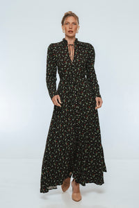 Woman wearing a black floral dress on a white background