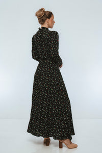 Woman wearing a black floral dress on a white background