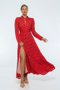 Woman wearing a red dress with a slit on a white background