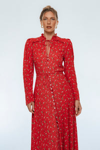 Woman wearing a red floral dress on a white background