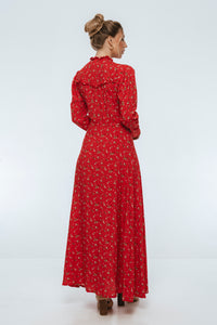 Woman wearing a red floral dress on a white background