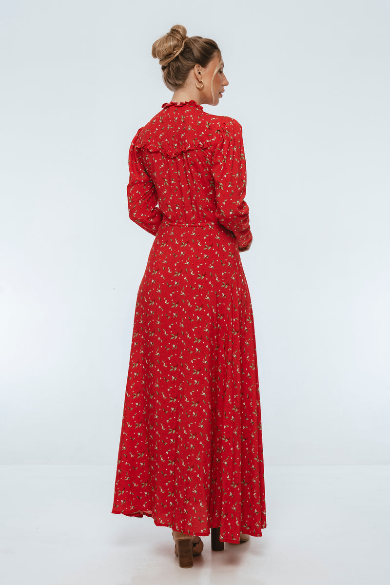 Woman wearing a red floral dress on a white background