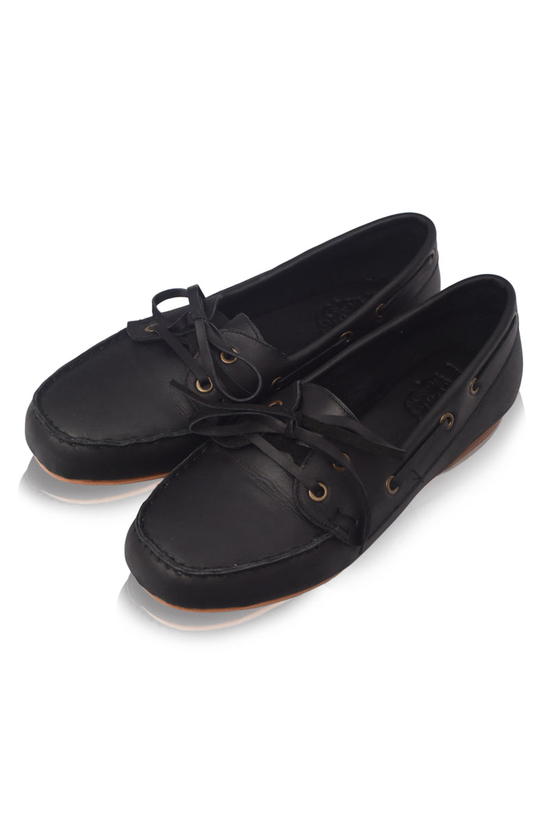 Pair of black leather boat shoes on a white background