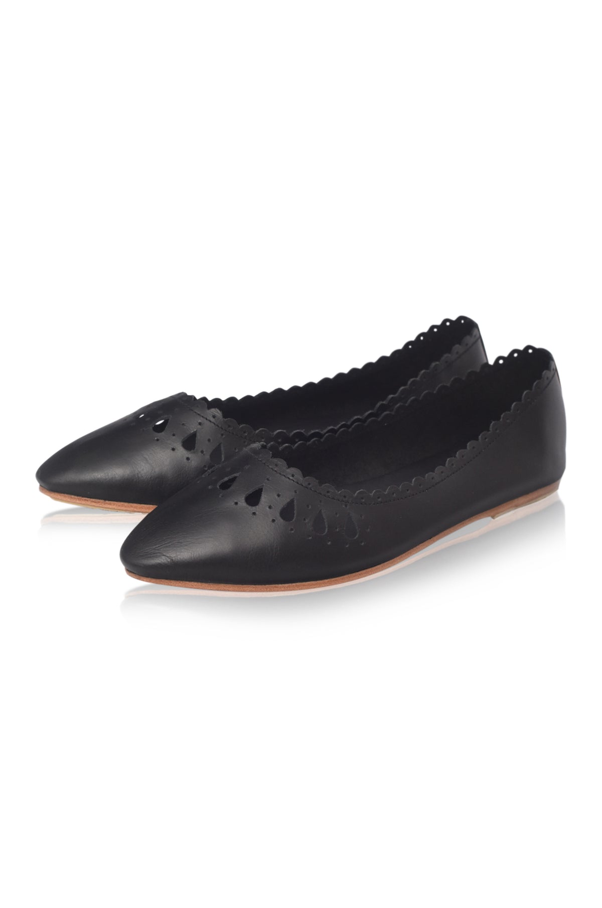 A pair of black leather pointed-toe flats with decorative cutouts and scalloped edges, shown on a clean white background.