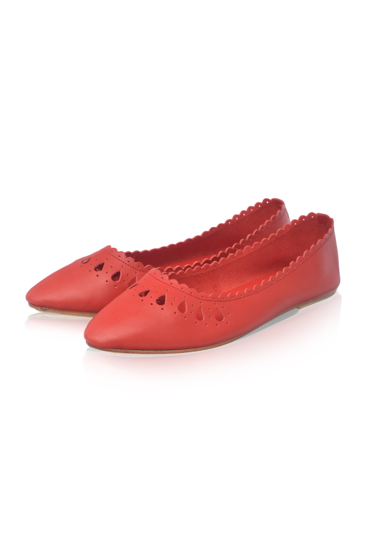 A pair of red leather ballet flats with pointed toes, decorative heart-shaped cutouts, and scalloped edges, shown on a white background.