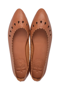 A pair of tan leather pointed-toe flats with decorative cutout detailing along the vamp, shown from a top-down view on a white background.