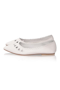 A pair of white pointed-toe flats with scalloped cutout detailing along the vamp, shown against a plain white background.