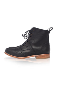 Black leather ankle boot with brown sole on a white background