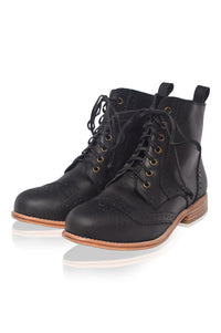 Pair of black leather boots with brown soles on a white background