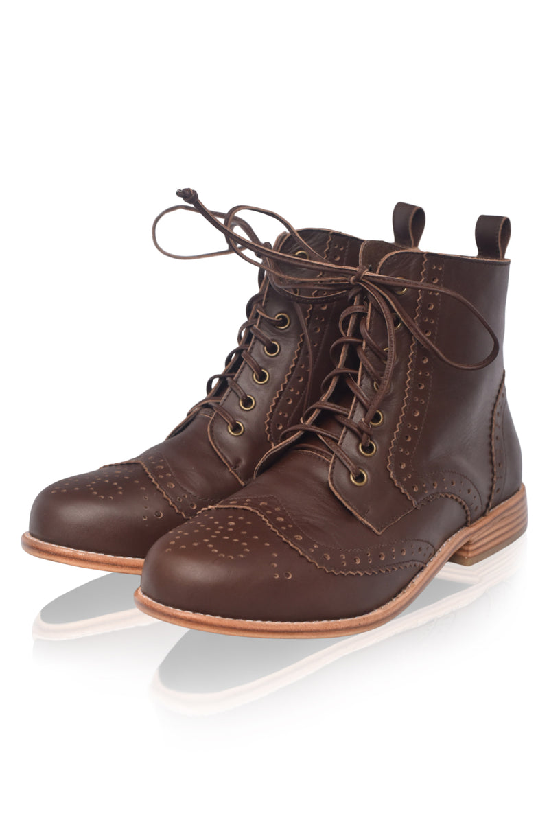 Pair of brown leather boots on a white background