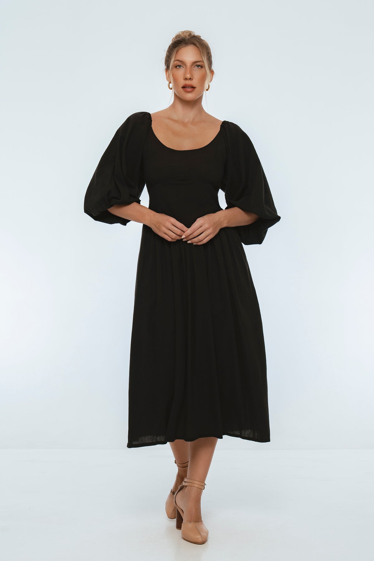 Woman wearing a black dress on a white background
