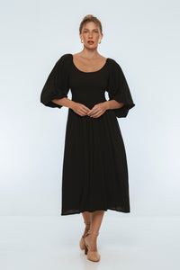 Woman wearing a black dress on a white background