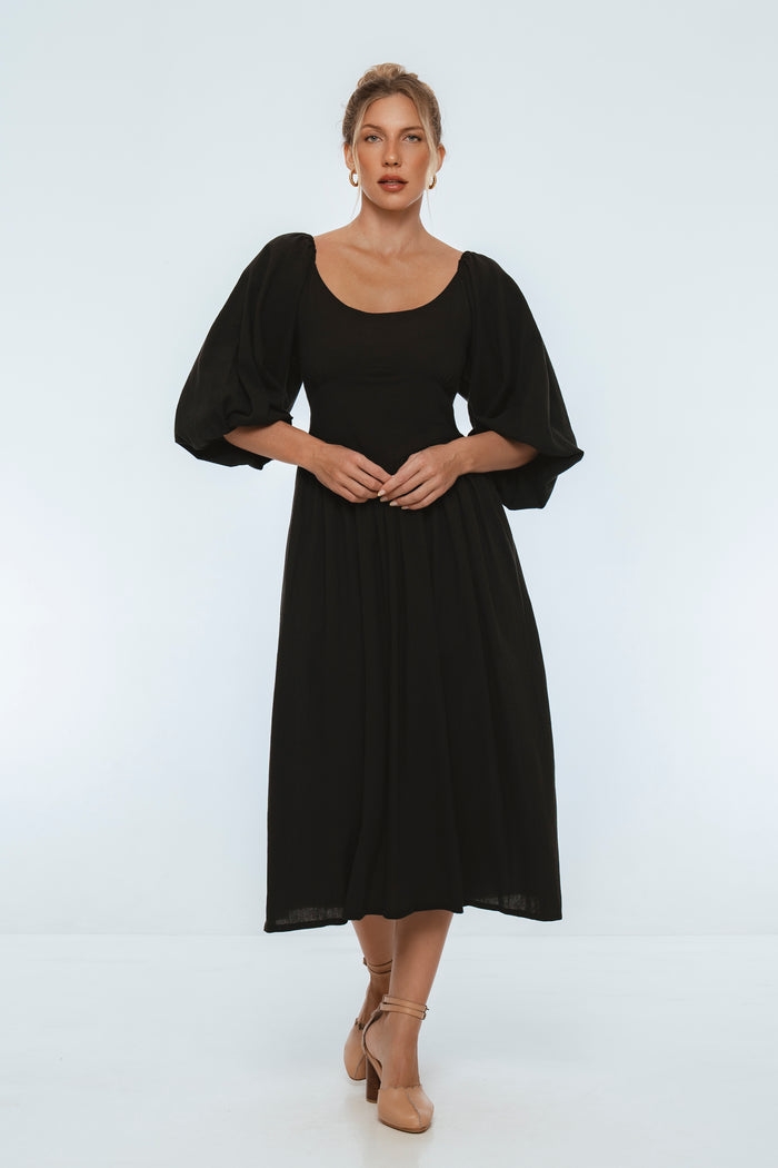 Woman wearing a black dress on a white background