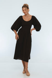 Woman wearing a black dress on a white background