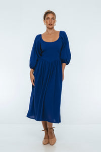Woman wearing a blue dress on a white background