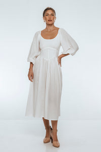 Woman wearing a white dress on a white background