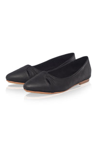 Pair of black flat shoes on a white background