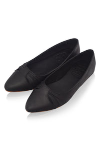 Pair of black pointed-toe flats on a white background