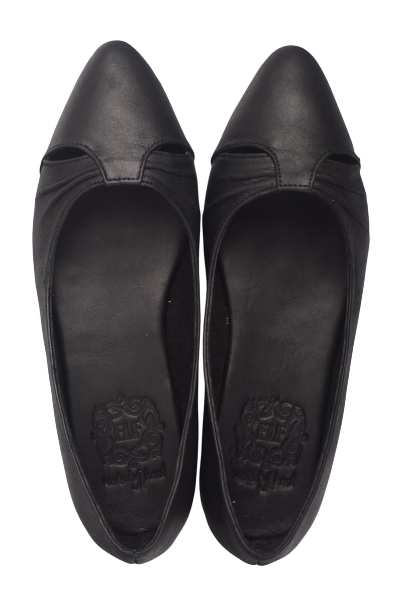 Pair of black pointed-toe shoes on a white background
