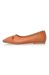 Tan leather flat shoe on a white background