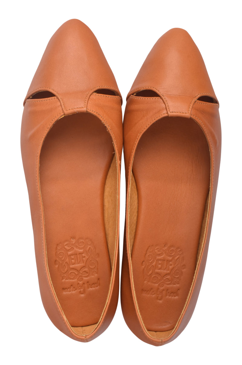 Pair of brown leather shoes with cut-out design on a white background