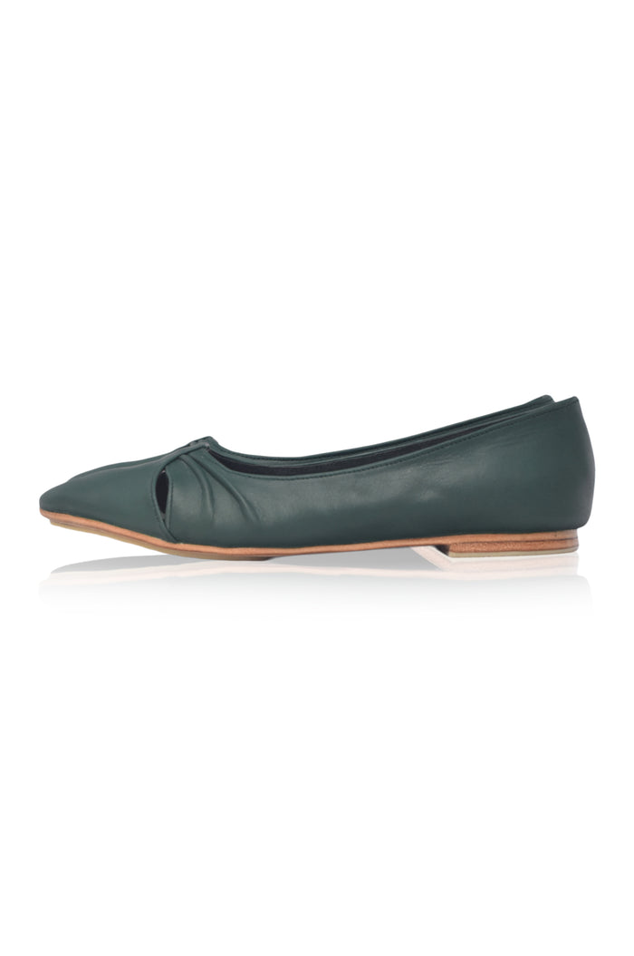 Green flat shoe on a white background