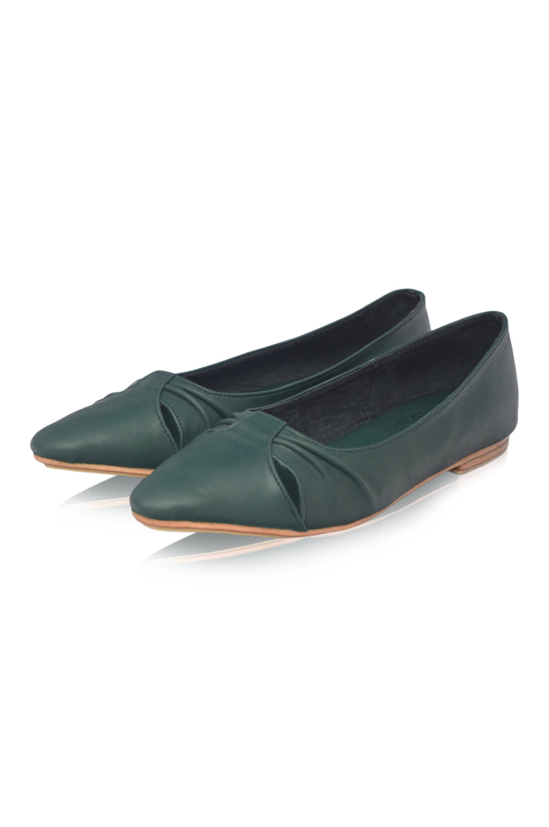 Pair of green flat shoes on a white background