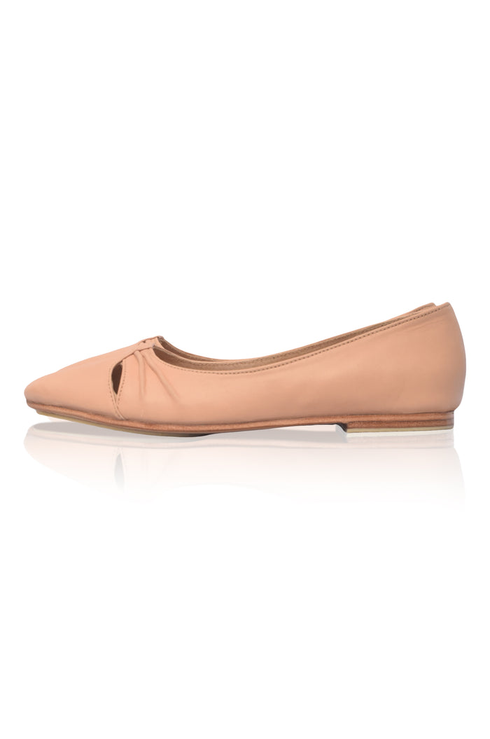 Nude-colored flat shoe on a white background